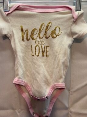 Baby Essentials Cream One-Piece Bodysuit with Pink Trim and Gold Glitter Print